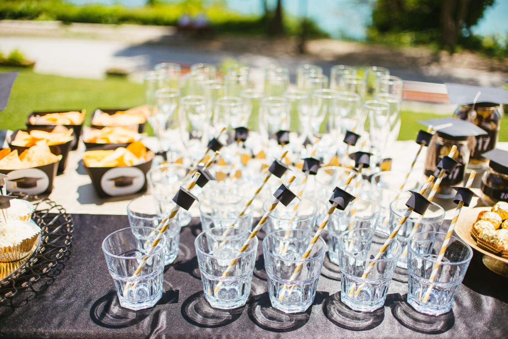 A table with many glasses of water and drinks.