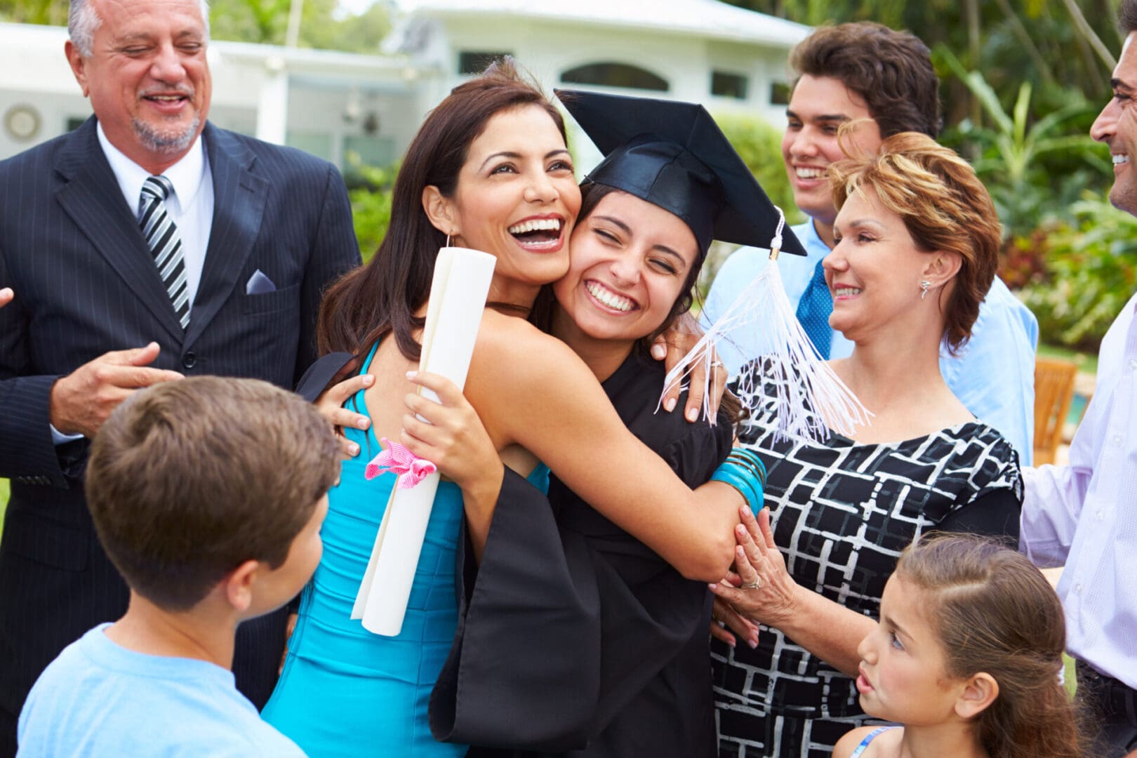 A group of people gathered around hugging and smiling.