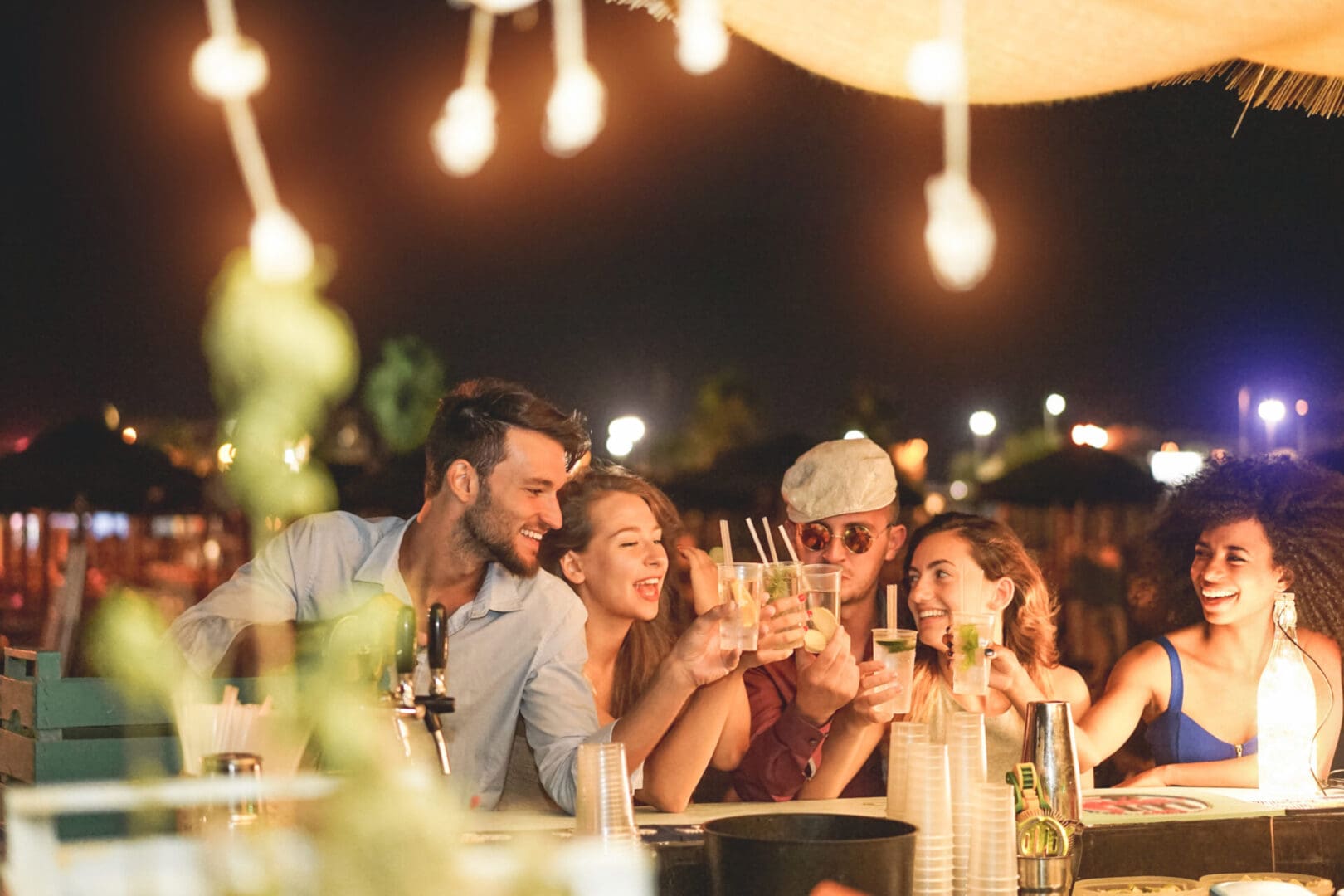 A group of people sitting at a table with wine glasses.