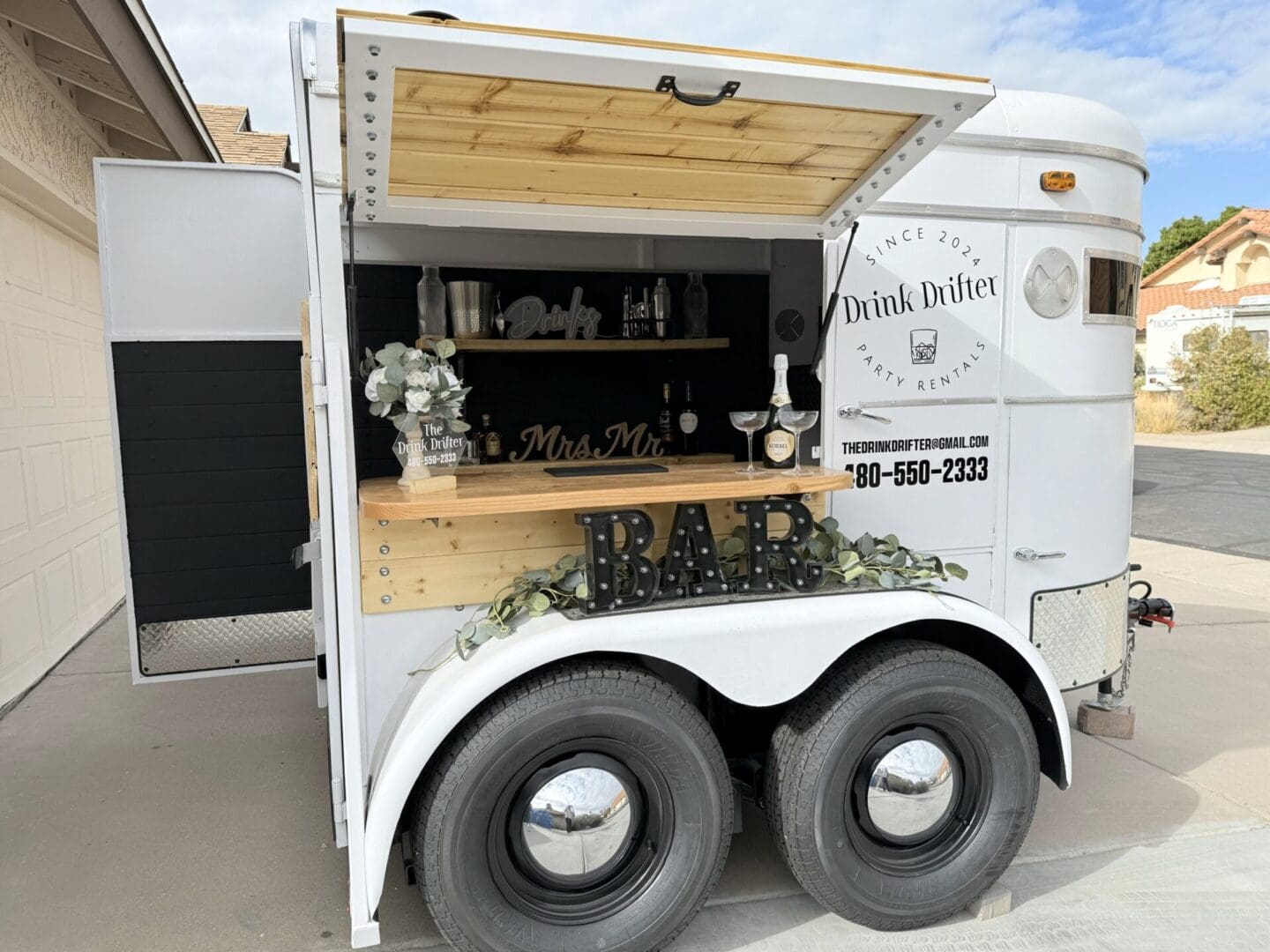 A white trailer with a bar on the side.